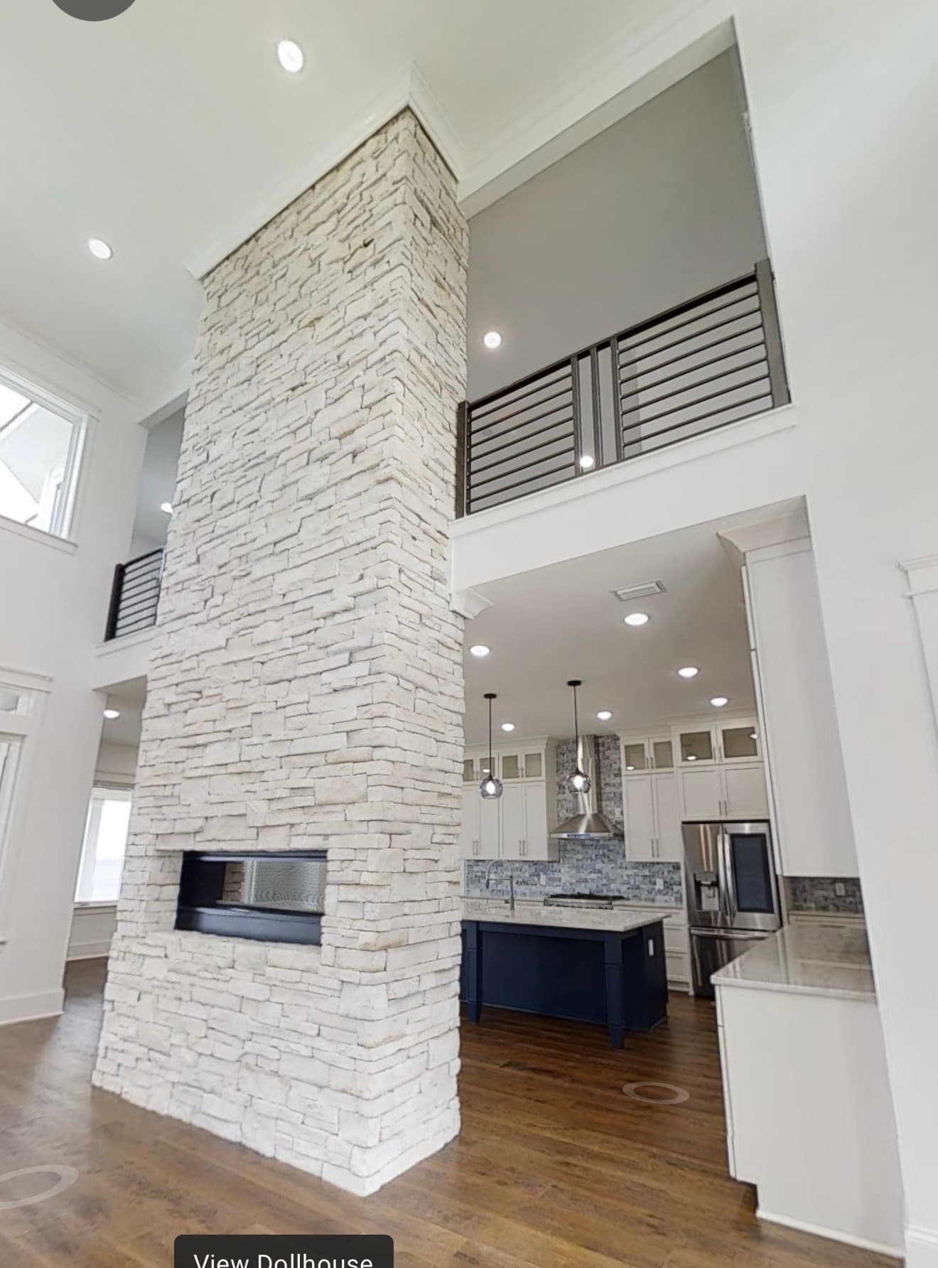 White kitchen with marble island and globe pendants