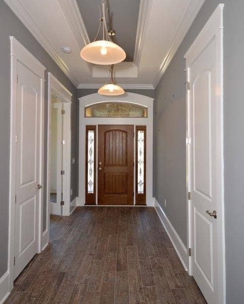 Gray hallway leading to arched front door