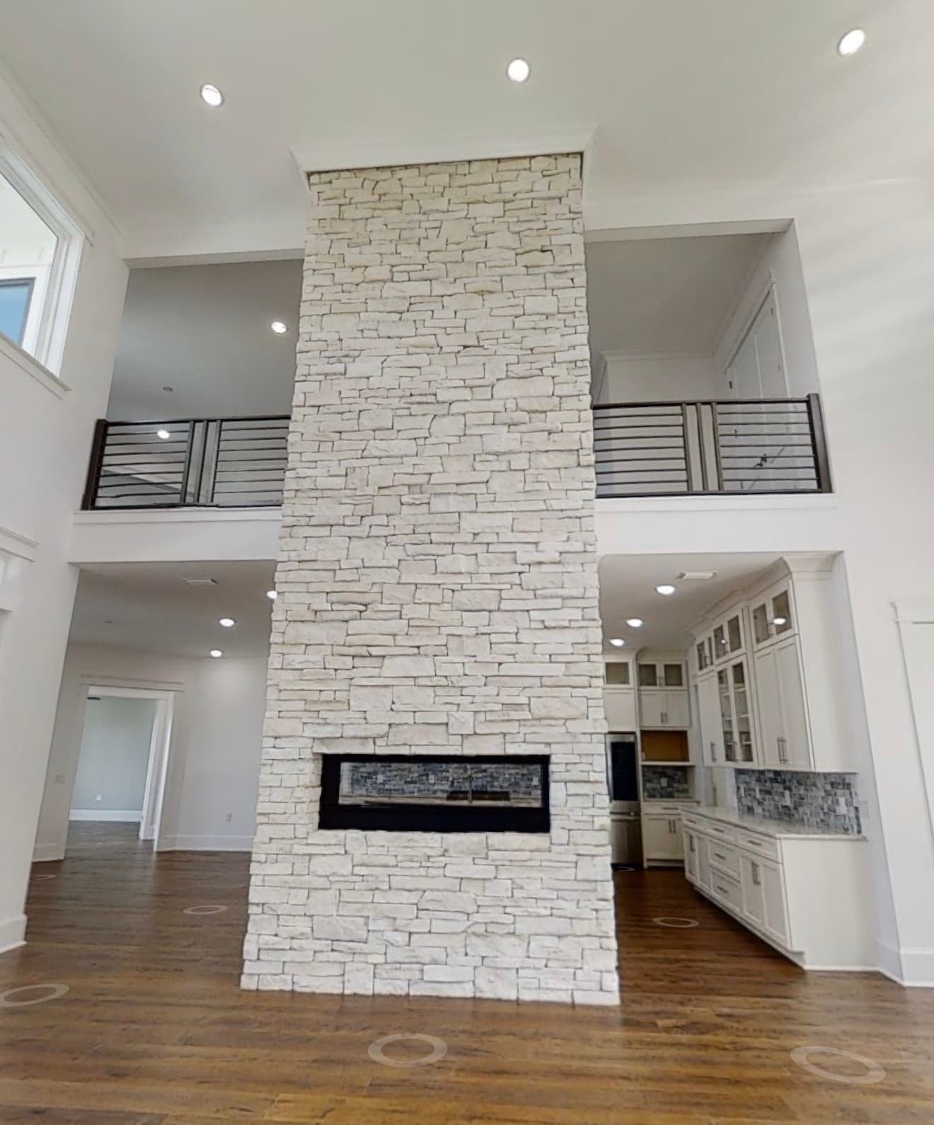 Great room with floor-to-ceiling stone fireplace