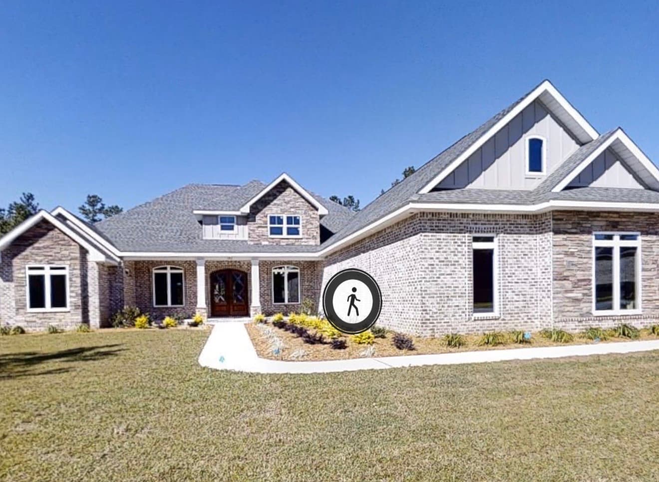 Brick and stone ranch with landscaped front lawn